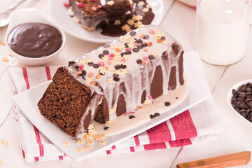 Sponge cake with white frosting and sugars.