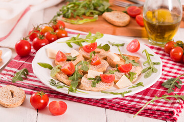 Friselle with cherry tomatoes and arugula.