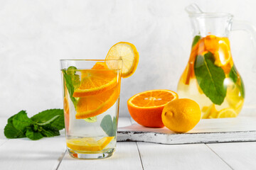Citrus drink with lemon, orange and mint. Healthy and healthy drink in a transparent glass with...