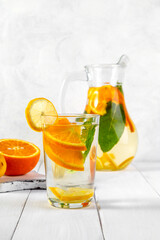 Citrus drink with lemon, orange and mint. Healthy and healthy drink in a transparent glass with copy space