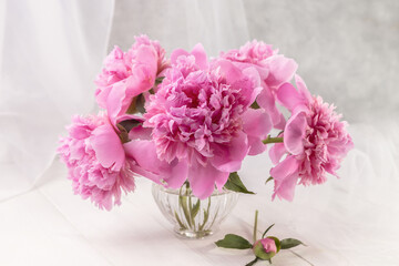 Bouquet of pink peonies in a vase on a wooden table. Gift Valentine's Day