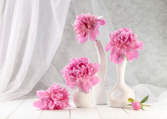 Bouquet of pink peonies in a vase on a wooden table. Gift Valentine's Day