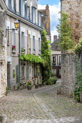 Senlis, medieval city in France, typical cobblestone street with ancient houses
