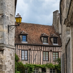 Fototapeta na wymiar Senlis, medieval city in France, typical cobblestone street with ancient houses 