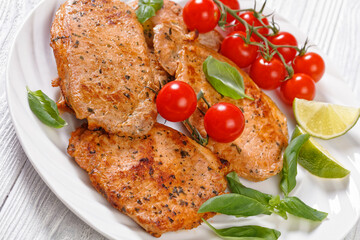tomato basil pesto fried pork cutlets on plate