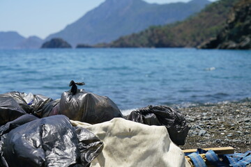 bags of collected garbage from the beach for recycling, cleaning the beach from pollution