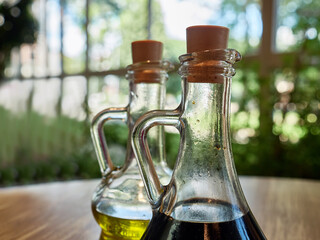 On the table are containers with oil and soy sauce. Seasoning for food.