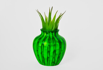 green vase with a green plant