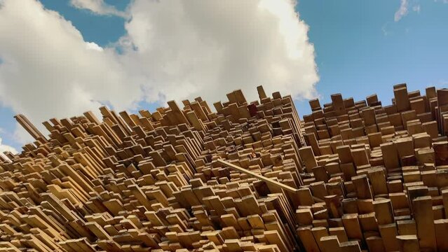Wooden boards, lumber, industrial wood, timber. Pine wood timber stack of natural rough wooden boards on building site. Industrial timber building materials