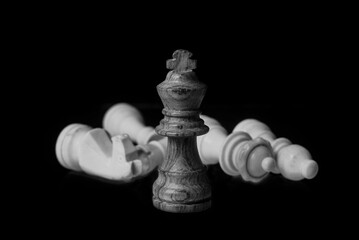 wood chess king pieces isolated on a black background.