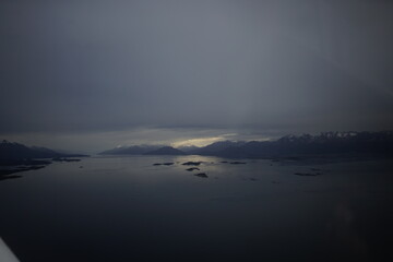 the photo captures the moment of takeoff and flight by plane over Ushuaia — a city and port in southern Argentina.