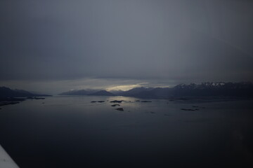 the photo captures the moment of takeoff and flight by plane over Ushuaia — a city and port in southern Argentina.