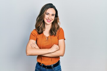 Young hispanic girl wearing casual clothes happy face smiling with crossed arms looking at the camera. positive person.