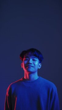 Perfect choice. Neon light guy. Special offer. Red blue color Asian man approving invisible product with thumbs up isolated on dark vertical advertising copy space background set of 4.