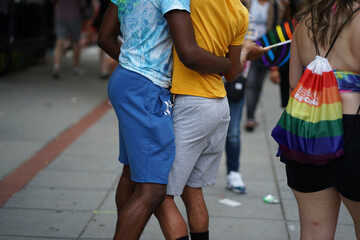 Coupl of young gay black american gay males dansing in the street during gay pride in Washington DC