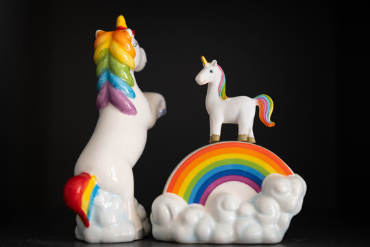 rainbow unicorn figures on the black background 