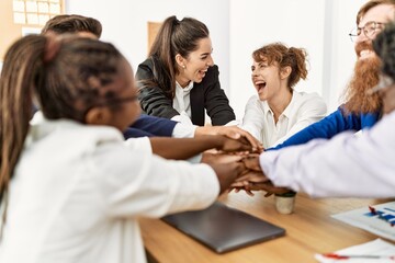 Group of business workers smiling happy celebrating with hands together at the office.