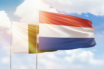 Sunny blue sky and flags of netherlands and pakistan