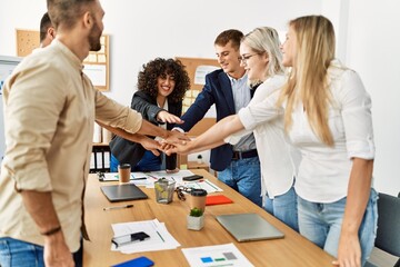 Obraz premium Group of business workers smiling happy celebrating with hands together at the office.