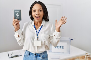 Young african american woman at political campaign election holding usa passport celebrating victory with happy smile and winner expression with raised hands