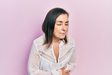 Fototapeta premium Middle age hispanic woman wearing casual clothes with hand on stomach because indigestion, painful illness feeling unwell. ache concept.