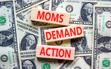 Moms demand action symbol. Concept words Moms demand action on wooden blocks on a beautiful...