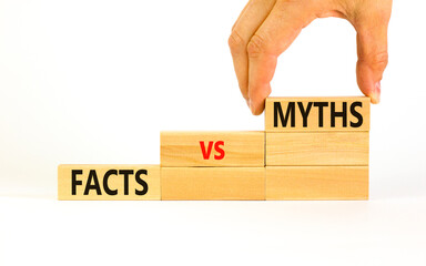 Facts vs myths symbol. Concept words Facts vs myths on wooden blocks on a beautiful white table white background. Businessman hand. Business, finacial and facts vs myths concept. Copy space.