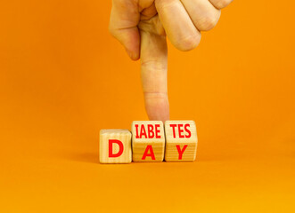 Diabetes day symbol. Concept words Diabetes day on wooden cubes. Doctor hand. Beautiful orange...