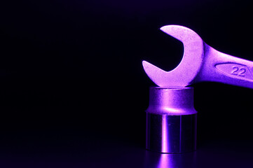 Violet chrome vanadium spanner is standing on the top of hexagon head. Metal composition. Macro picture. Space for text. Background picture.