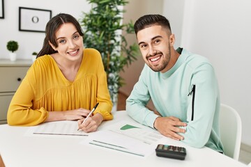 Obraz premium Young couple controlling family economy at home.