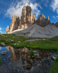 Mountain reflection in lake by Tre Cime di Lavaredo in Dolomites - obrazy, fototapety, plakaty