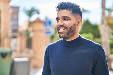 Fototapeta premium Young hispanic man smiling confident standing at street