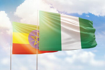 Sunny blue sky and flags of nigeria and ethiopia