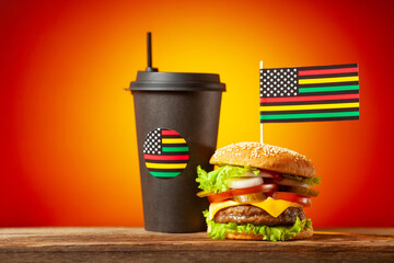 Classic American burger with alternative African American juneteenth flag on the top and black...
