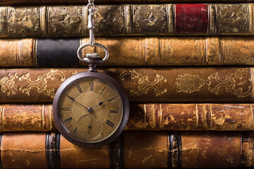 Vintage pocket watch with old books. Still life 