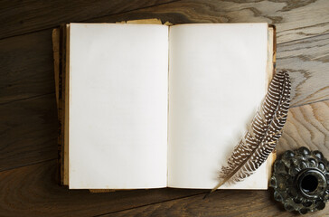 Old antique book opened on blank pages. Ancient pages with quill pen and bottle of ink - Powered by Adobe