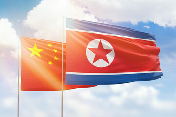 Sunny blue sky and flags of north korea and china