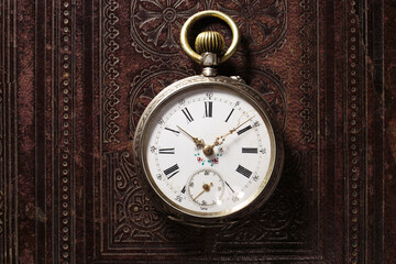 Old classic antique pocket watch on leather bible background