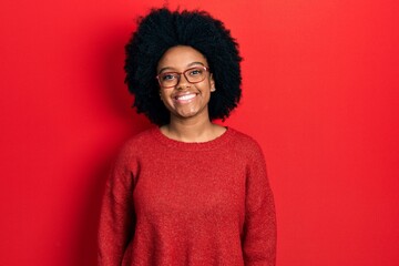 Obraz na płótnie Canvas Young african american woman wearing casual clothes and glasses with a happy and cool smile on face. lucky person.