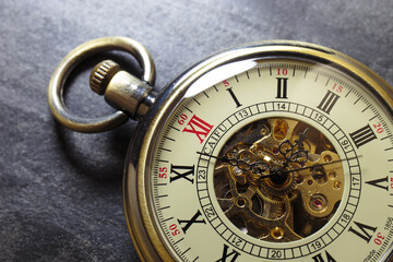 Antique clock on a stone background