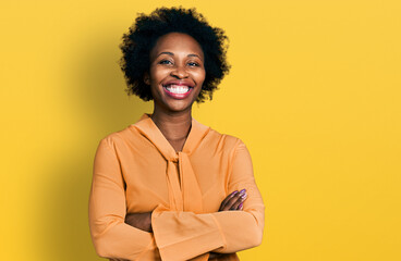 African american woman with afro hair wearing elegant shirt happy face smiling with crossed arms...