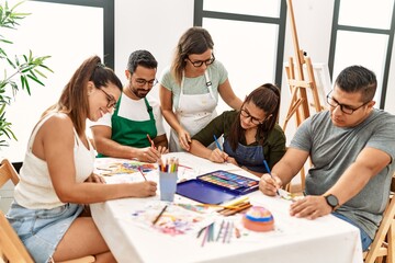 Group of draw students sitting on the table drawing at art studio.