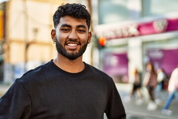 Fototapeta premium Young arab man smiling confident at street
