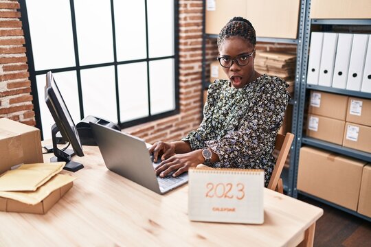 Beautiful Black Doctor Woman Working At Small Business Commerce In 2023 Scared And Amazed With Open Mouth For Surprise, Disbelief Face