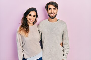 Young hispanic couple wearing casual clothes with a happy and cool smile on face. lucky person.