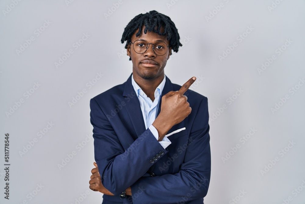 Sticker young african man with dreadlocks wearing business jacket over white background pointing with hand f