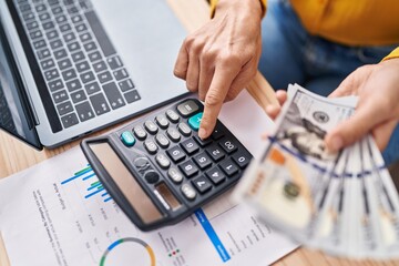Young woman ecommerce business worker counting dollars at office