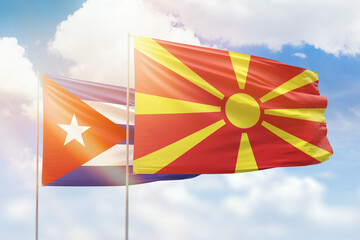 Sunny blue sky and flags of north macedonia and cuba