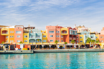 Panoramic seascape on multicolored houses on the seafront of Egypt, Hurghada. Colorful Marina promenade street from Red Sea with part of the azure surface of the sea © Anna Skliarenko