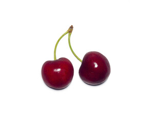 Two bright ripe cherries on a white background. Berries with a stem.